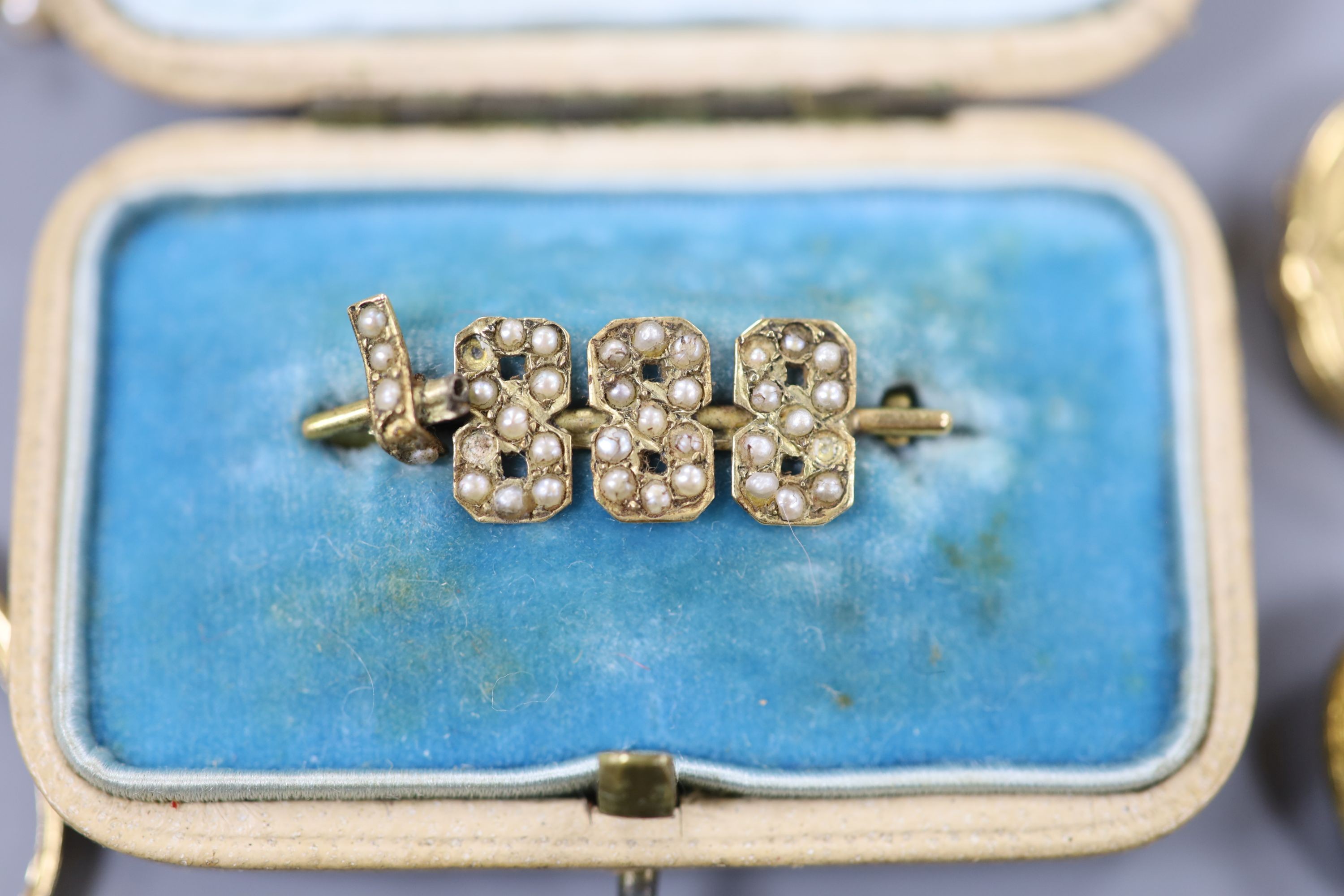 A modern engraved 9ct gold circular locket, gross 4.6 grams a 15ct and seed pearl set golf club bar brooch, gross 2.8 grams and other minor jewellery.